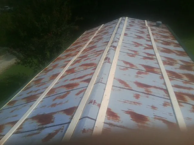 Rusted metal roof panels with new wood purlins before replacement — Storm Damage Roof Repair in Pantego by Roofing Brothers